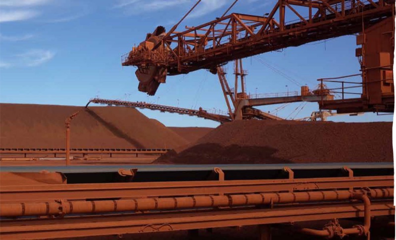 Stacker and conveyor infrastructure over an iron ore stockpile