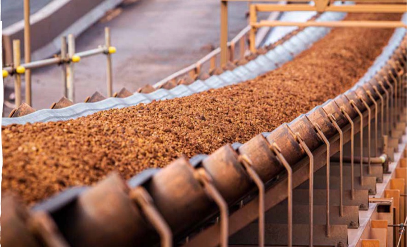 Ore moving along a conveyor belt at a processing facility